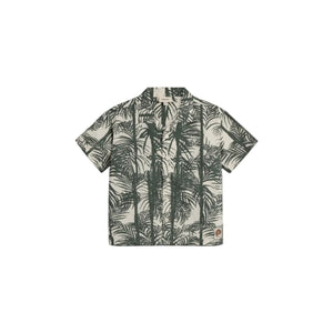 Short-sleeved shirt features a tropical palm leaf print in dark green on a light background. It has buttons down the front and a collar, set against a plain backdrop.
