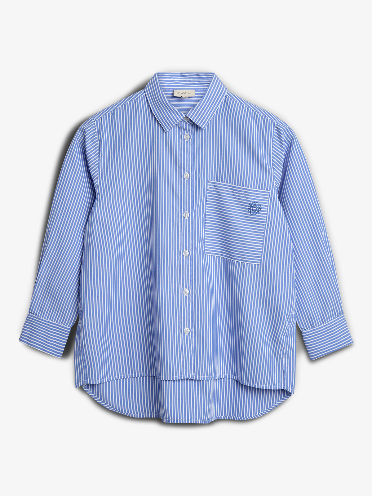 Blue and white striped button-up shirt with a collared neck and long sleeves. It features a front pocket with an embroidered logo, set against a plain white background.
