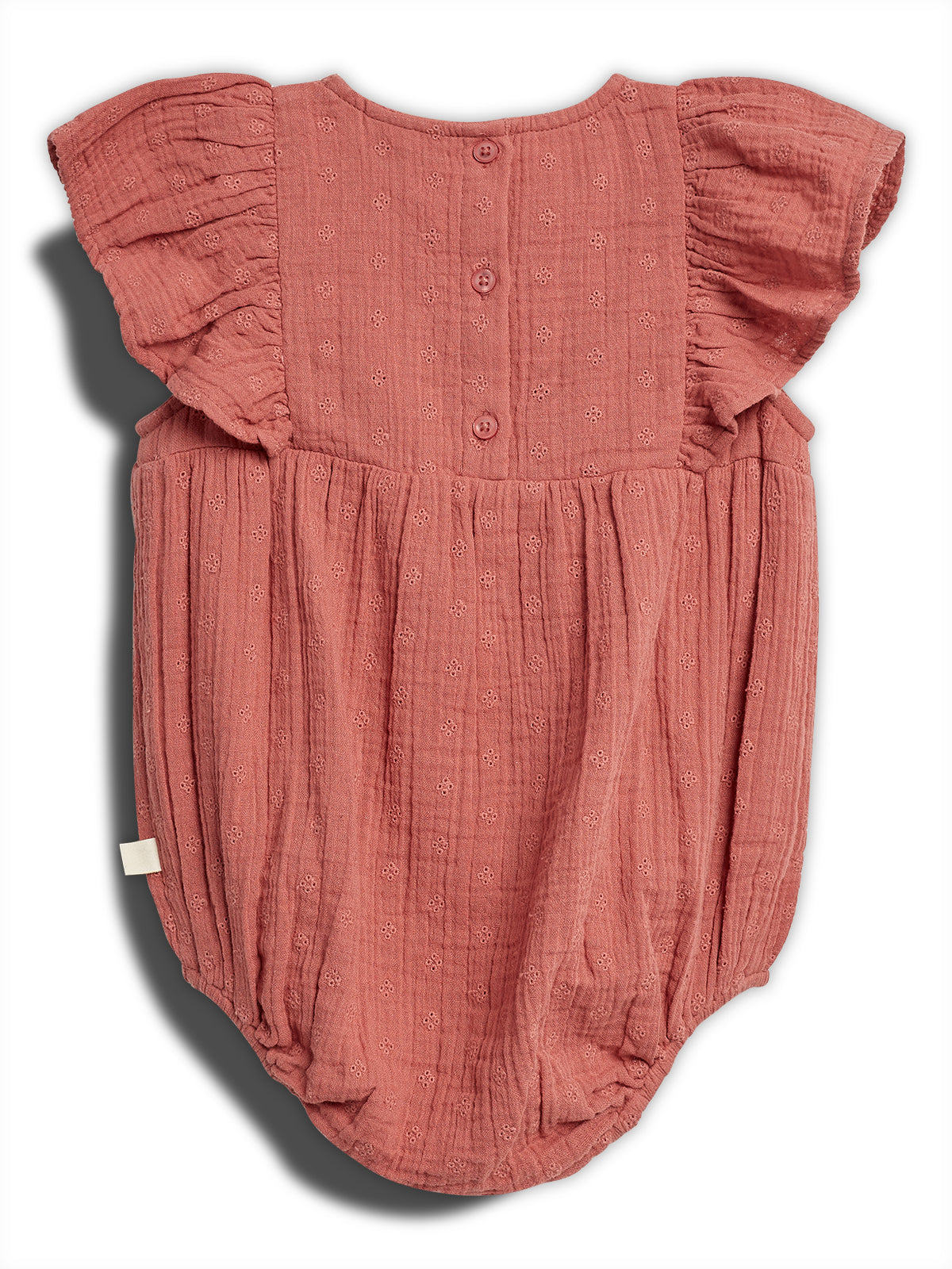 The romper is pink with ruffled sleeves, adorned with small embroidered patterns. It's buttoned down the back, providing a delicate design suitable for babies, set against a plain backdrop.