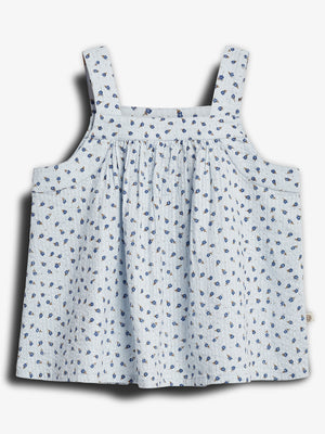 A light blue sleeveless top with thin straps, adorned with a pattern of small blue flowers, displayed against a plain white background.