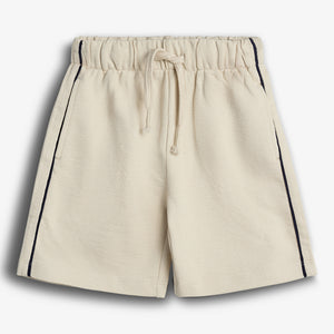 Beige shorts with an elastic waistband and drawstring, featuring dark vertical stripes on the sides, displayed against a plain white background.